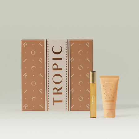 The Vanilla Crème & Cinnamon Bark Fine Fragrance and Body Cream Set from Tropic, featuring a decorative gift box with a body cream tube and fine fragrance bottle displayed in front.